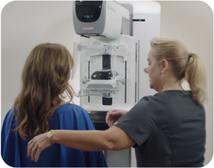 woman receiving mammogram with a technician