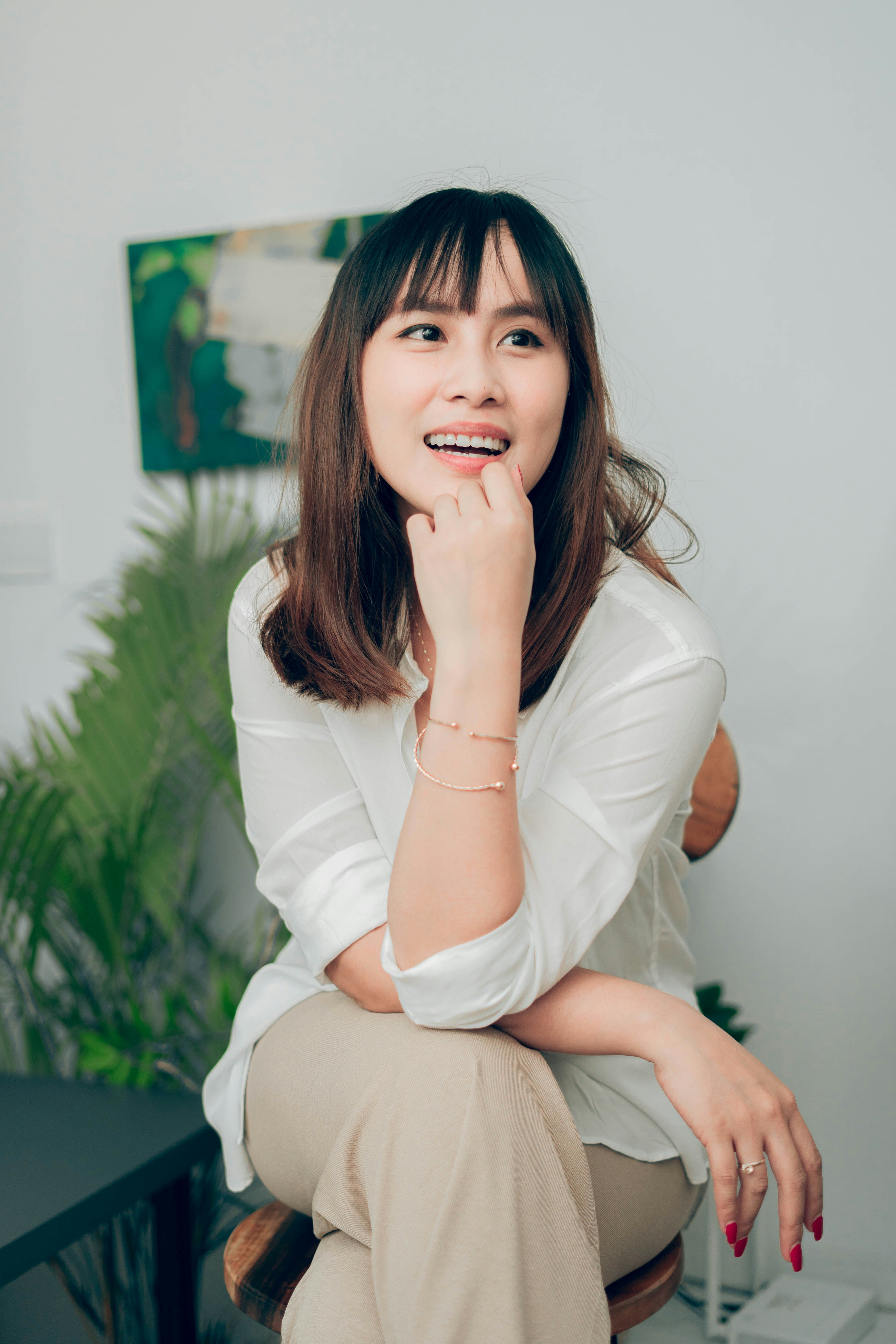 A smiling woman seated in an office